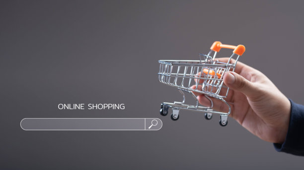 一只手握着迷你购物车象征着在线购物趋势。这张图片捕捉了电子商务和数字市场增长的本质。图片下载