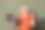 漂亮年轻女孩的照片肖像，手持笔记本电脑，做出“OK”手势，眨眼，穿着时尚的橙色服装，背景为卡其色。图片下载