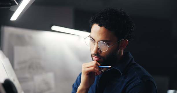 创意、艺术家在绘图板上思考草图创意，插图截止日期或图片灵感。夜晚，男士或插画师进行视觉设计的头脑风暴或加班项目。图片下载