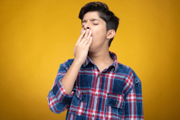 穿着格子衬衫的年轻男孩，背景为黄色，适合用作库存照片图片下载