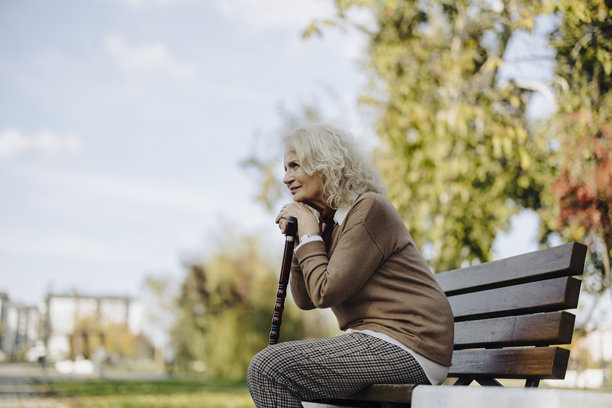 公园里手持拐杖的老年人照片。图片下载