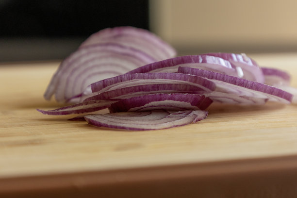 红洋葱切片特写照片，放在木板上图片下载