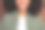 穿着卡其色衬衫的微笑棕发年轻女士的裁剪照片，背景为棕色。图片下载