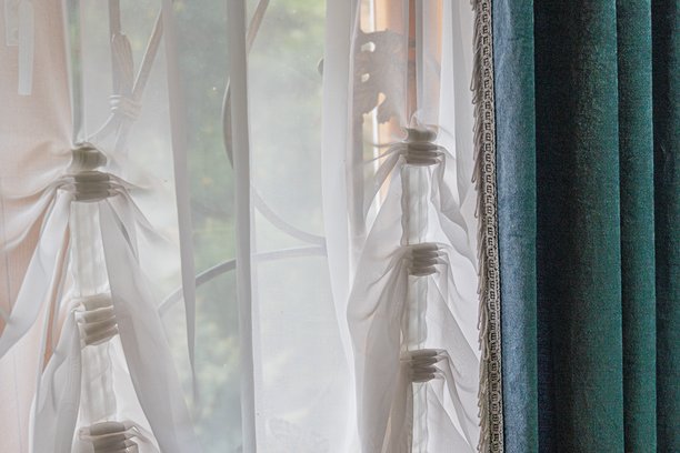 多层叠加的照片创造出重叠效果，展示了一扇部分拉开的窗帘窗户。阳光透过窗帘和玻璃洒入，投射出图案。这种风格是摄影拼贴。图片下载