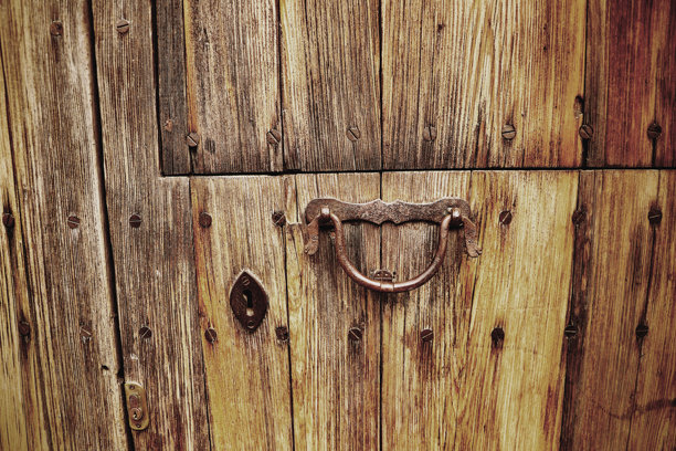旧木门上有一个生锈的铁门环。特写照片。图片下载