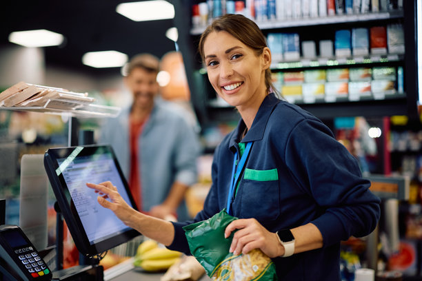 在超市工作的快乐收银员微笑着看向镜头。图片下载
