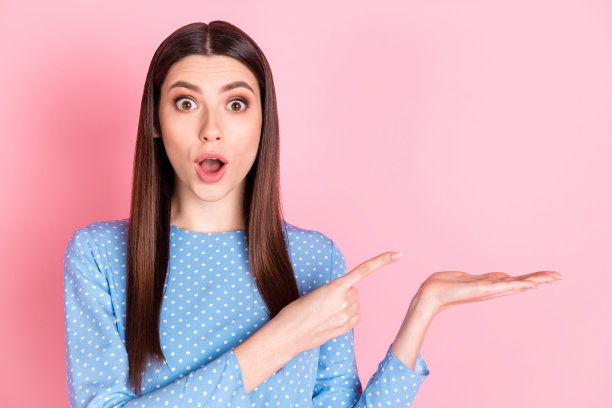 年轻女孩惊讶、震惊、惊喜的照片，推荐产品优惠，背景为粉色。图片下载