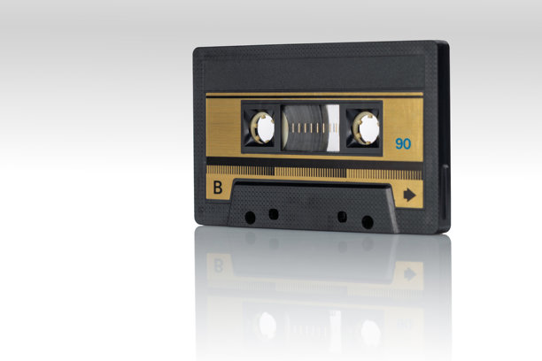 复古磁带录音带，金色标签在光滑的白色表面上反射图片下载
