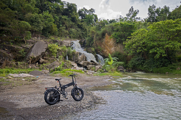 在瀑布旁的越野电动山地自行车图片下载