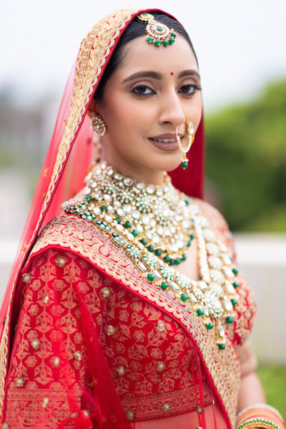 非常美丽的年轻印度新娘，身着奢华的婚礼服装，化着妆，佩戴着华丽的珠宝，户外拍摄的肖像照片图片下载