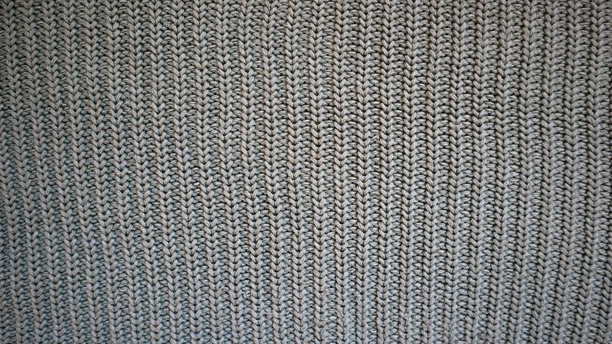 背景充满了灰色针织面料的纹理。照片。图片下载