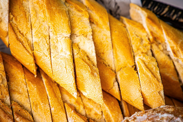 新鲜香气四溢的面包摆放在桌上。面包店食品概念全景或宽幅横幅照片背景图片下载