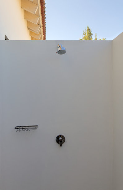 安提瓜危地马拉酒店房间内的户外淋浴（奢华旅行，外部沐浴，淋浴头，水龙头，肥皂架，旋钮）金属白墙，炎热气候，极简风格照片图片下载