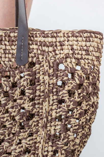 女性手持时尚编织包。时尚与奢华配饰。竖版照片。图片下载