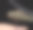 特写照片显示一只蜻蜓栖息在人的手指上，背景为黑色。图像展示了它的大复眼、透明的翅膀、细长的身体和纤细的昆虫腿。图片下载