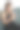 年轻女性坐在舒适的沙发上，使用玻璃指甲锉修整指甲，享受轻松愉悦的家庭美容时光。竖版照片图片下载