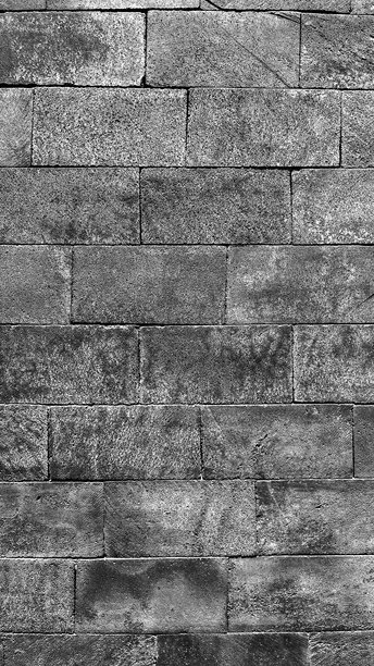 灰色石墙的特写照片，呈矩形块状图案。图片下载