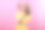 Asian woman in a yellow dress and straw hat smiles sweetly with hands resting under chin, creating a cute and peaceful expression. Shot against a vibrant pink background in studio lighting图片下载