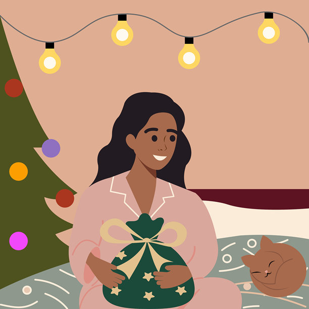 穿着睡衣的女孩在节礼日里抱着圣诞礼物图片下载