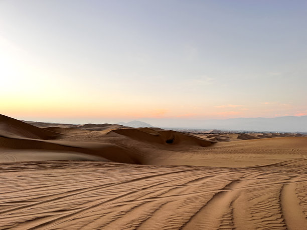 沙丘的景观和由越野车留下的疲惫痕迹，穿越秘鲁伊卡的华卡奇纳沙漠地区的干旱风景。图片下载