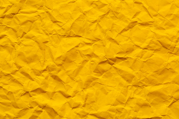 黄色皱纹纸质感的特写，皱纹的黄色纸张特写。细致的照片纹理背景。图片下载