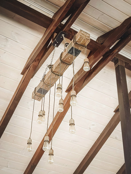 复古吊灯悬挂在木梁天花板上。特写，竖版照片。图片下载