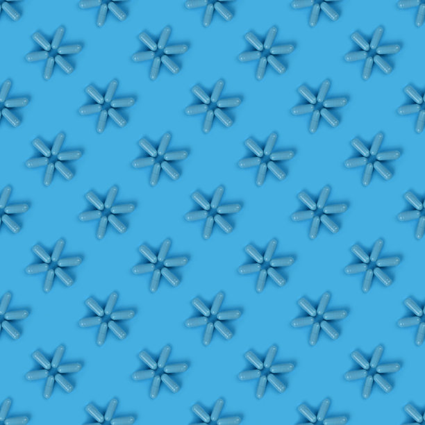 蓝色医用胶囊药丸在蓝色背景上。高分辨率照片。图片下载