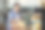 一位年长女性在温馨的咖啡馆内浏览糕点展示，仔细查看面包和甜点选项，捕捉到家庭经营咖啡店中安静的商业时刻和对品质的关注。图片下载