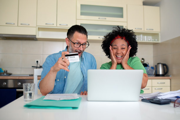 一对兴奋的夫妇用信用卡庆祝网上购物成功 - 库存图片图片下载