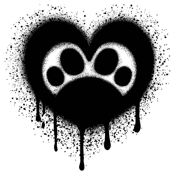 心形符号内的涂鸦猫爪印，黑色喷漆。矢量插画。图片下载