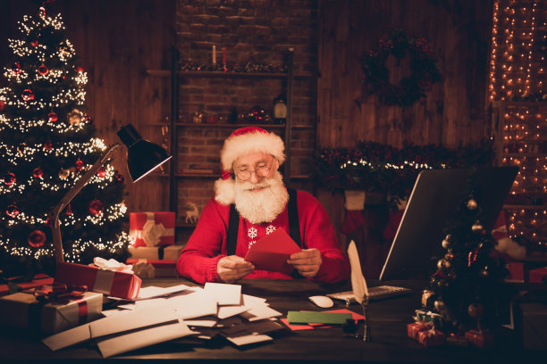 照片，年长的圣诞老人，快乐积极的微笑，阅读信件，许愿，工作室，新年灯饰，圣诞节，室内图片下载