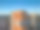 垂直航拍HDR照片，展示了日落时格但斯克Przymorze地区现代的橙白色高层建筑，突出几何立面。图片下载