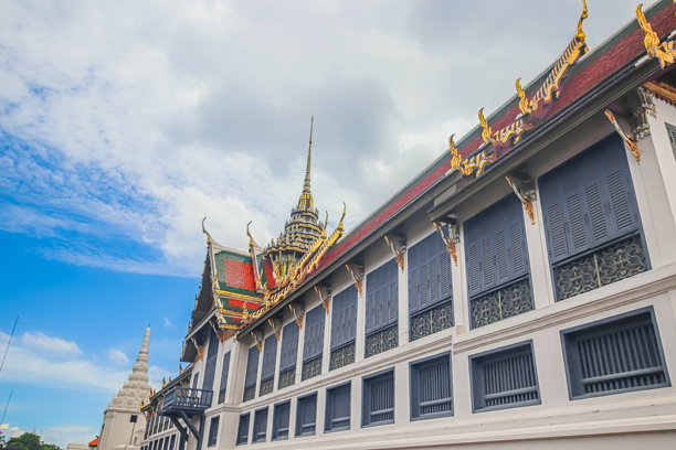 曼谷大皇宫的素泰萨万宫殿，装饰华丽的泰式屋顶、尖塔和历史悠久的皇家建筑，在戏剧性的多云天空下。图片下载