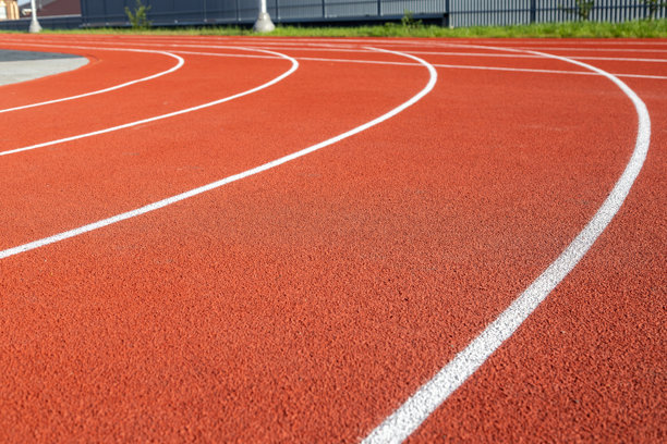 带有白色标记线的红色跑道，由橡胶材料制成的运动场馆表面。运动场馆规划、运动基础设施设计、景观建筑。真实照片图片下载