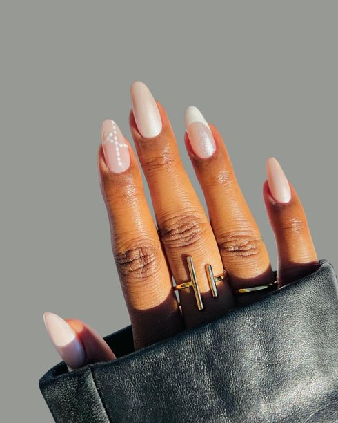 年轻女子光滑的棕色皮肤手，展示着优雅的现代美甲和创意手绘美甲设计图片下载