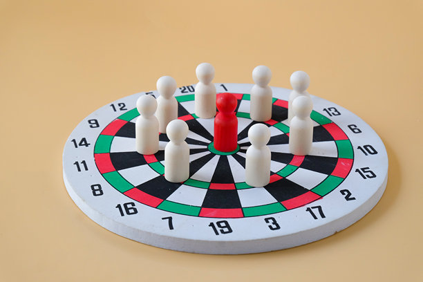 木制玩偶在飞镖盘上，象征合作与互动图片下载