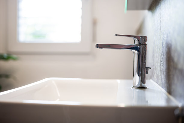 现代方形浴室洗脸盆或水槽及镀铬水龙头。广角，侧视图，浅景深，自然窗户光线，无人图片下载