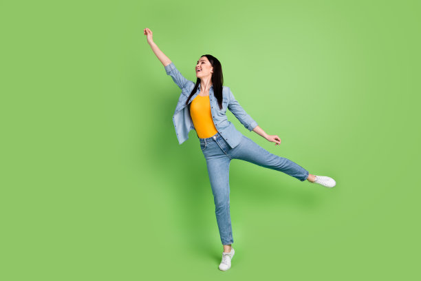 年轻迷人的梦想家微笑着，手持隐形雨伞，侧身拍摄，背景为绿色，全尺寸个人资料照片图片下载