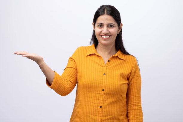 身穿黄色库尔塔服装的中年女性，纯白背景下的照片素材图片下载