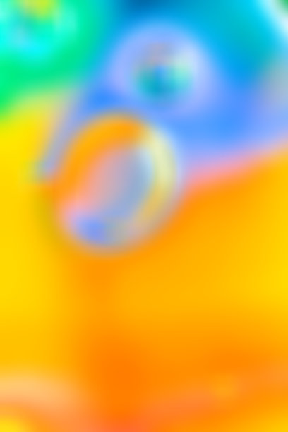 抽象的模糊宏观照片，带有柔和的气泡，呈现绿色、蓝色和紫罗兰色调，背景为明亮的橙色和黄色。平滑的渐变过渡，圆形。可复制空间图片下载