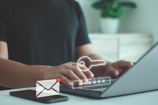 多因素身份验证概念。一名男子在笔记本电脑上输入密码，通过手机上的电子邮件消息图标保护互联网上的数据账户。网络安全的两步验证。图片下载