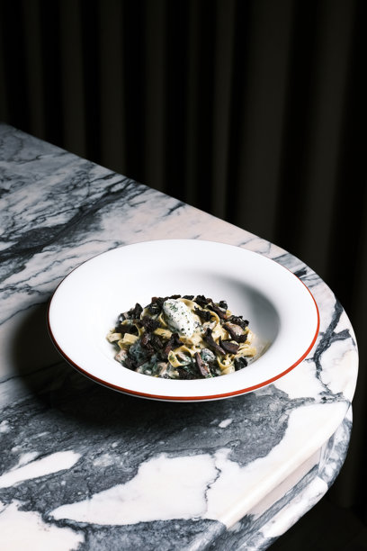 奶油野菌意大利宽面，俯视视角，摆放在大理石餐桌上，置身于意大利餐厅的氛围中，近距离展示精致美食，带有泥土般的质感和香草点缀，适用于菜单设计和食品品牌推广的烹饪概念。图片下载