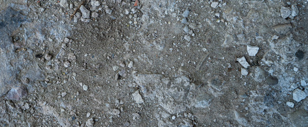 近距离拍摄地面的灰黑色熔岩纹理。多孔、开裂、石质，非常适合用作素材纹理或照片背景。给人一种熔融岩石的质感。图片下载