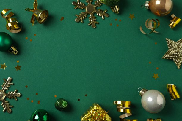 圣诞装饰概念。金色装饰品纸屑在绿色背景上的俯视照片，留有空白空间图片下载
