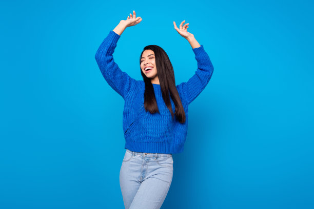 年轻女孩穿着休闲服在派对上欣喜若狂地跳舞，照片肖像，孤立在充满活力的蓝色背景前图片下载