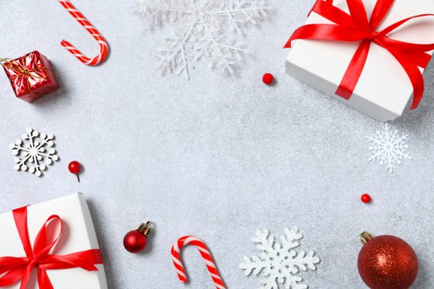灰色背景上精美的节日画框，装饰着系着蝴蝶结的礼物盒图片下载
