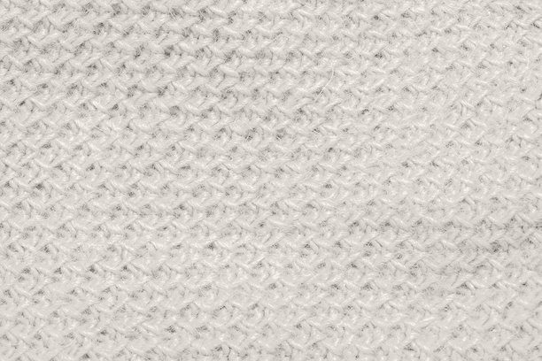 特写镜头展示了纹理丰富的云舞者（Cloud Dancer）面料，非常适合用作背景和设计素材。图片下载