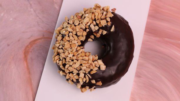 各种巧克力甜甜圈，配有不同的顶部装饰。照片以 45 度角、正面视角和俯视角度拍摄。图片下载