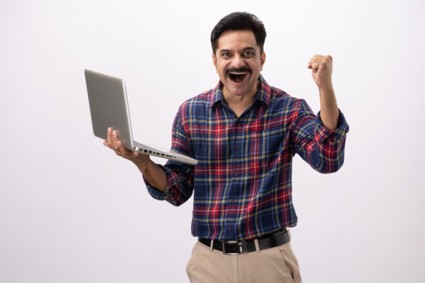 英俊的中年男子，穿着格子衬衫，使用笔记本电脑，背景为白色，单幅照片图片下载