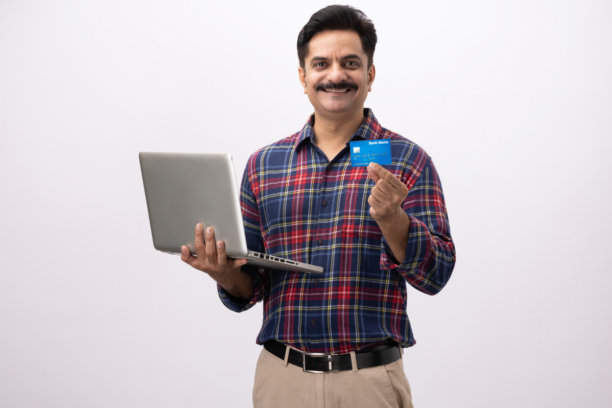 英俊的成年男性穿着格子衬衫，使用笔记本电脑，在白色背景下拍摄的素材照片图片下载